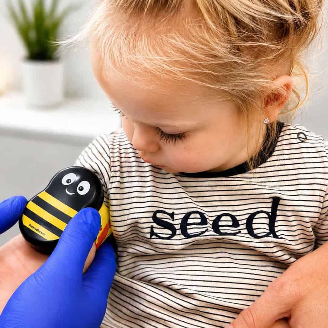 Toddler comforted with a bumble bee Buzzy device before a blood test at the BRAVE Clinic, Shire Family Medical, Sutherland