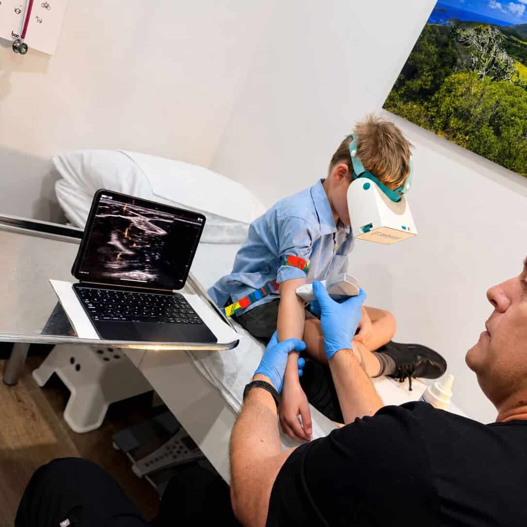 Boy wearing a VR headset during ultrasound-guided blood collection at the BRAVE Clinic, Shire Family Medical, Sutherland