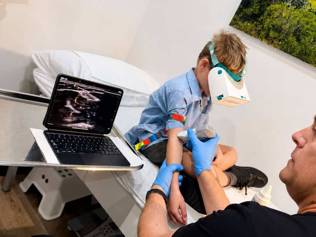 Boy wearing a VR headset during ultrasound-guided blood collection at the BRAVE Clinic, Shire Family Medical, Sutherland