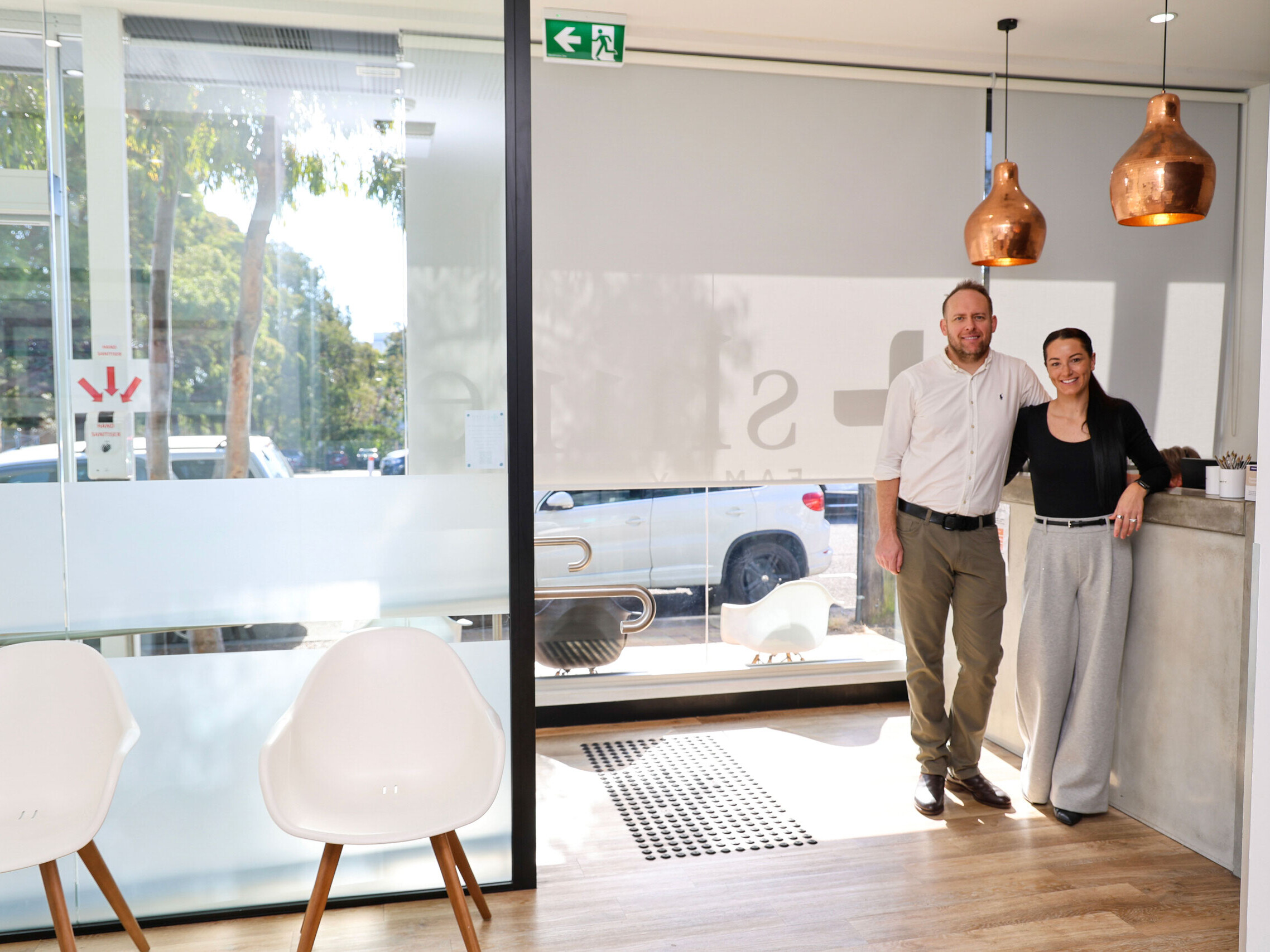 Dr Louis Traynor and Rebel Traynor, owners of Shire Family Medical, standing in the modern reception area of their Sutherland Shire GP practice.