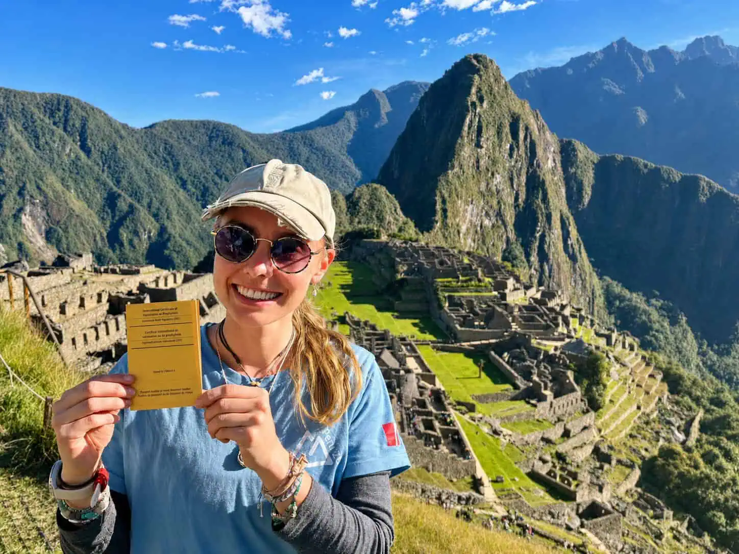 Traveller holding an International Certificate of Vaccination at Machu Picchu, Peru, after Yellow Fever vaccination at Shire Family Medical, Sutherland